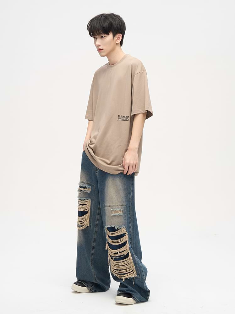Faded Distressed Patchwork Jeans - Image 10